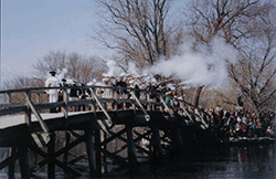 Sudbury Companies of Militia and Minute firing musket salute at North Bridge in Concord